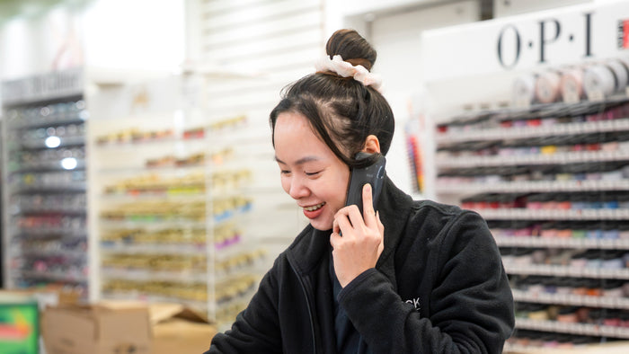 Lucky Nail Supply team member helping a customer by phone